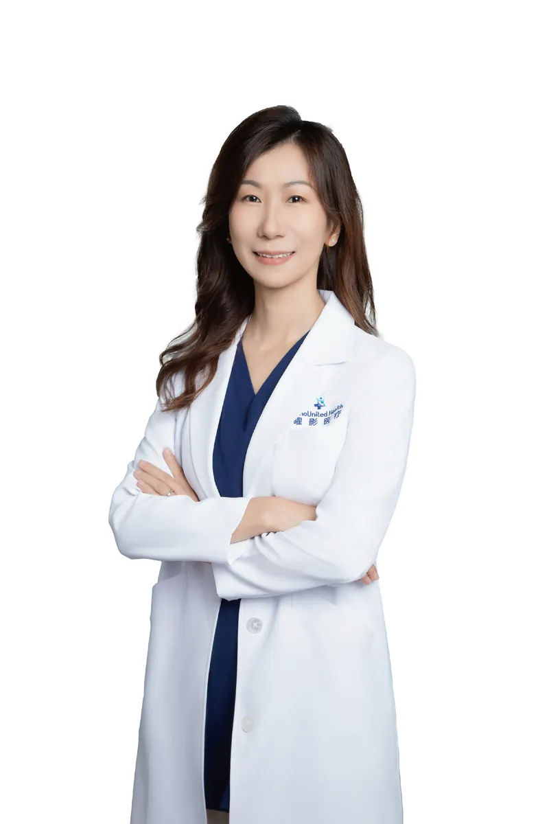 Dr. Lily Zhou, Chief of Hematology at SinoUnited Health, in a white clinical coat.