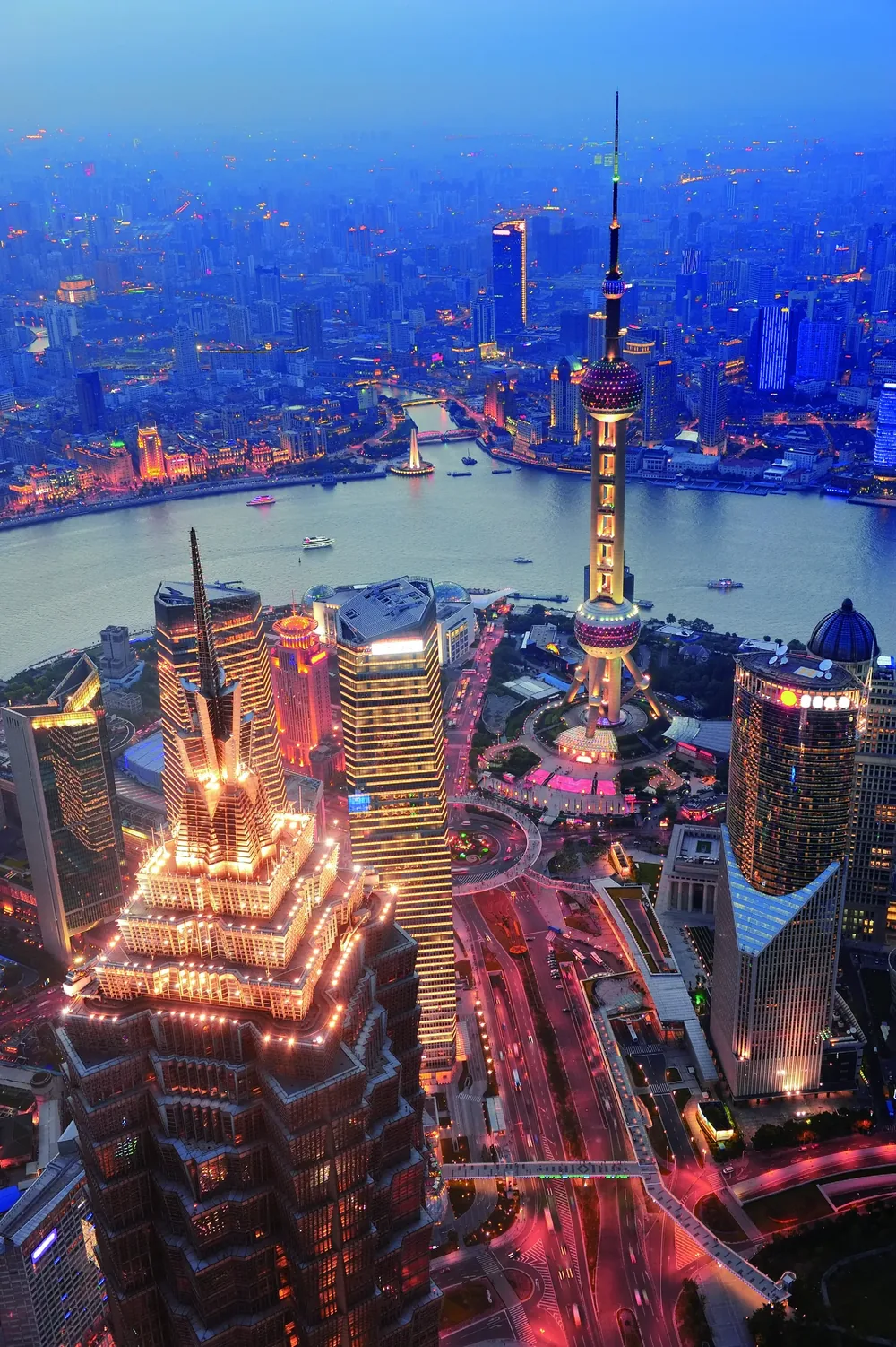 Aerial view of the Pudong financial district and Oriental Pearl Tower at dusk
